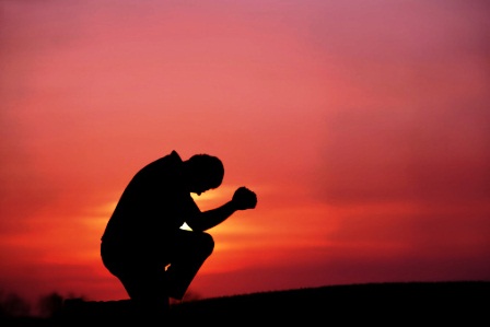 Silhouette of Man Praying at Dusk